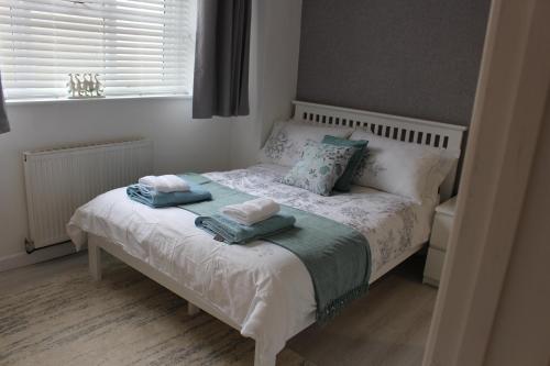 a bedroom with a bed with two towels on it at The Annexe in Ditcheat in Ditcheat