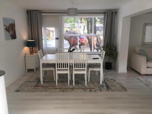 a white dining table and chairs in a living room at The Annexe in Ditcheat in Ditcheat