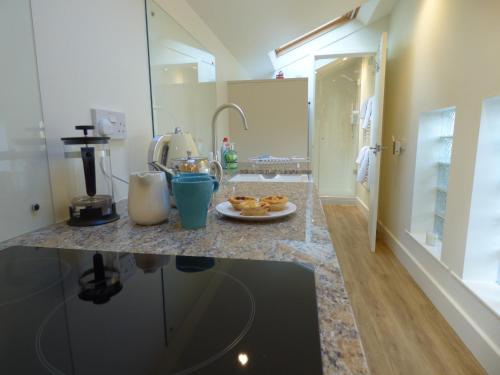 a kitchen with a counter with a plate of food on it at Hunters Moon B&B in North Tidworth