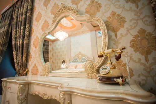 a dressing table with a mirror and a lamp at Caravan Castle Boutique Hotel in Bukhara