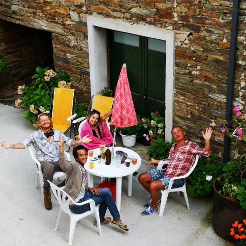 a group of people sitting around a table at Pensión Santa Rosa in Samos