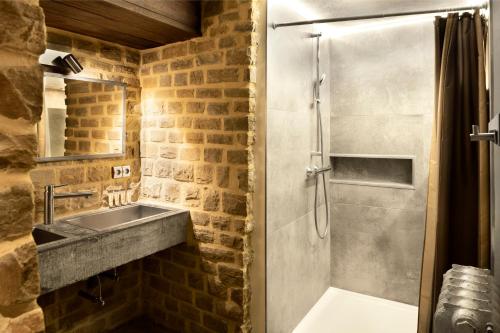 a bathroom with a sink and a shower at Appart-Hotel Léopold Liège Centre in Liège