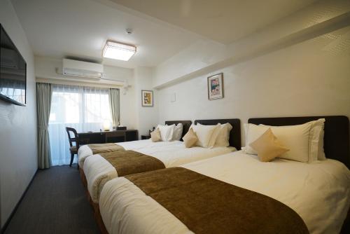 Postel nebo postele na pokoji v ubytování Le Tour Hotel Akihabara Ekimae 楽途ホテル秋葉原駅前店