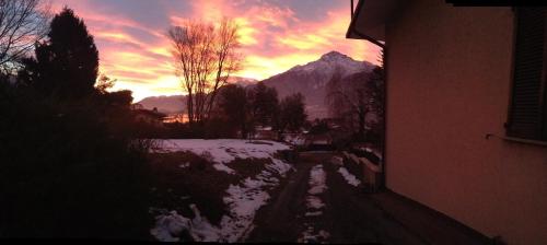 a winter sunset with a mountain in the background at Agriturismo Badalone in Domaso