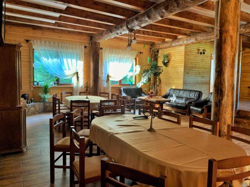 a large dining room with a table and chairs at Pensiunea Agnes in Durau