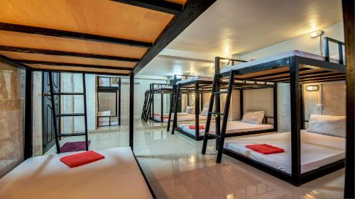 a group of four bunk beds in a room at Siem Reap Pub Hostel in Siem Reap