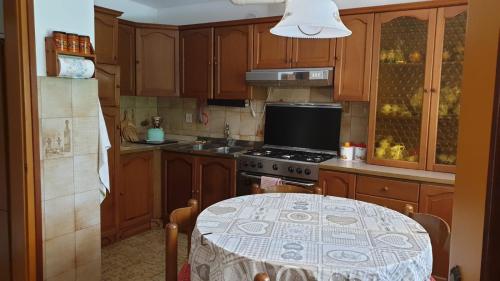 a kitchen with a table and a stove top oven at Villa Bontempo in Gleris