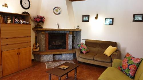 a living room with a couch and a fireplace at Villa Bontempo in Gleris