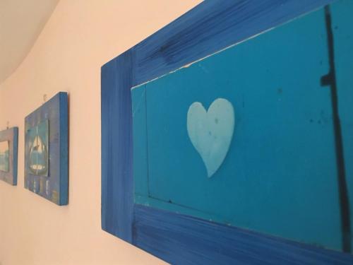 a blue wall with a picture of a bird on it at Casa Mafalda B&B in Lipari