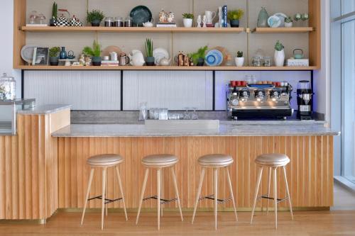 a kitchen with a counter with bar stools at Vida Creek Harbour in Dubai