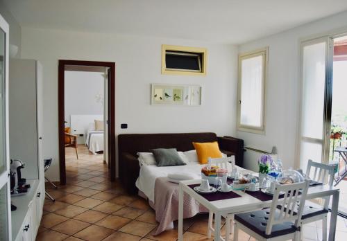a living room with a bed and a table at Residence Il Portico in Casale Monferrato