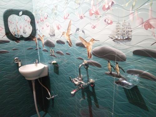 a bathroom with a mural of dolphins and a sink at Hotel Bachchan Palace in Varanasi