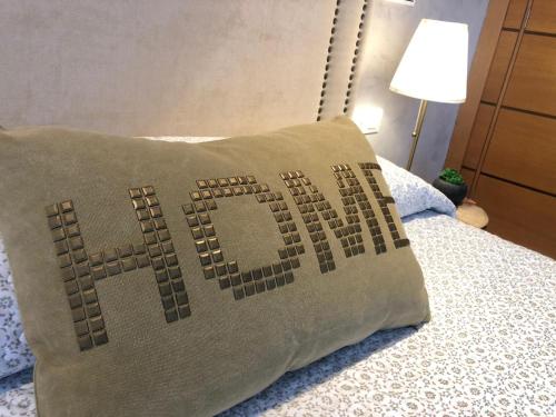 a pillow sitting on top of a bed at La Laguna Luxe Apartment in La Laguna