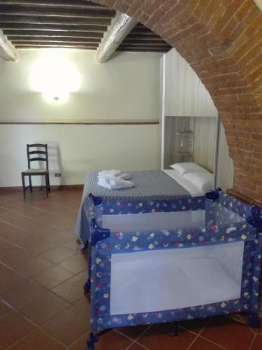 a bedroom with a bed in a room with a brick wall at Il Tasso in Pietraviva