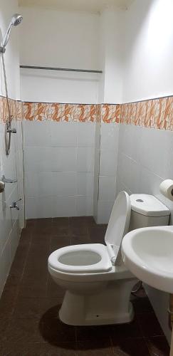 a bathroom with a toilet and a sink at Amelia Homestay in Puerto Princesa City