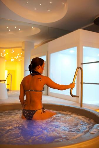 a woman in a bath tub with a faucet at Hotel Excelsior in Vasto