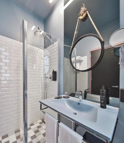 a bathroom with a sink and a mirror at The Modernist Hotel in Trieste
