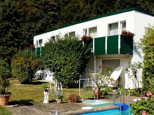 a house with a swimming pool in front of it at WALDHOTEL in Dierdorf