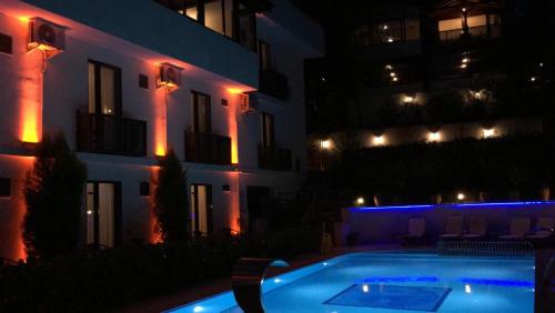 a swimming pool in front of a building at night at Sapanca Dilek Konagi Hotel in Sapanca