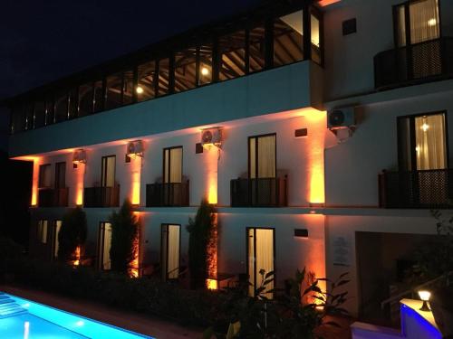 a large white building with lights on it at night at Sapanca Dilek Konagi Hotel in Sapanca