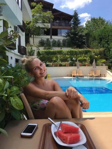 a man sitting at a table with a plate of watermelon at Sapanca Dilek Konagi Hotel in Sapanca