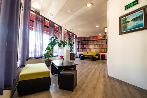 a room with a library with a table and a chair at Hotel Ostrova in Plovdiv