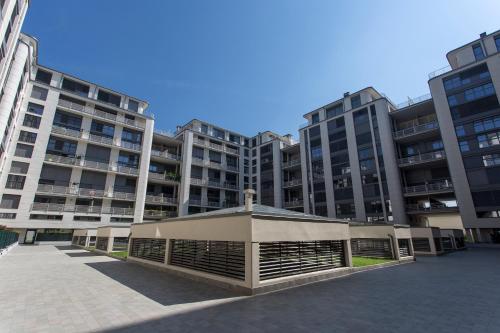a large apartment building with a pavilion in front of it at Unico Studios in Milan
