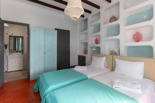 a bedroom with a bed with blue and white walls at Santo António's Guesthouse in Cascais