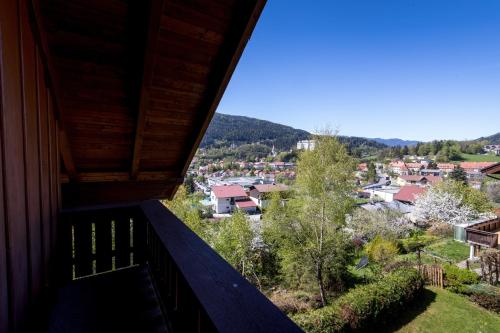 a balcony of a house with a view of a town at Haus Sonnseitn Murau für 6 bis 8 Personen in Sankt Egidi