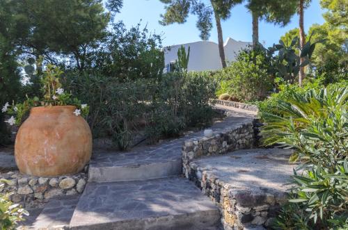 a large vase sitting on a set of stone steps at Villa dei Sogni in Vulcano