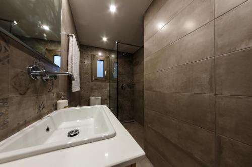 a bathroom with a white sink and a shower at San Marco Elegant Apartment Zante in Zakynthos