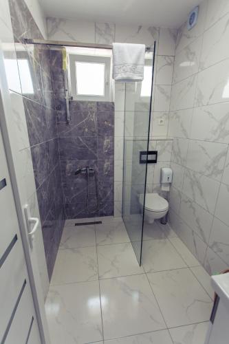 a bathroom with a shower and a toilet at CITY HOTEL in Ferizaj