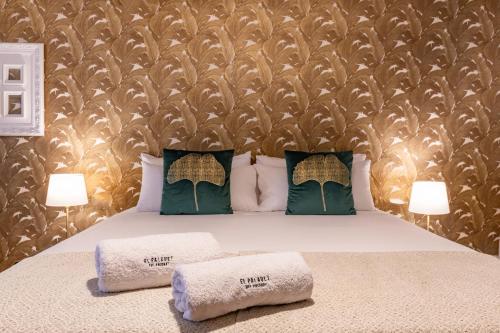 a bedroom with a bed with two towels on it at El Palauet del Priorat in Cornudella