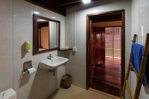 a bathroom with a sink and a mirror at Ratanakiri Paradise Hotel & Restaurant in Banlung