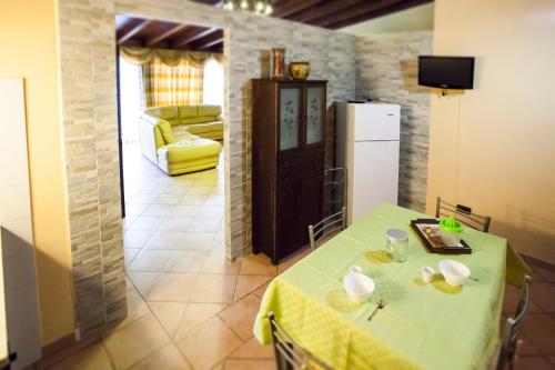 a kitchen with a table with a yellow table cloth at FILANNA HOME RELAX in San Vito lo Capo