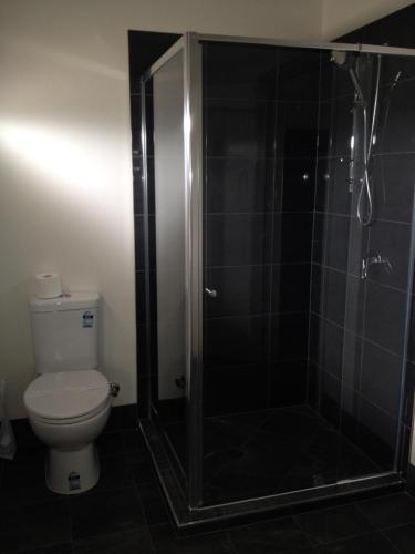 a bathroom with a shower and a toilet at Blackwater Hotel Motel in Blackwater