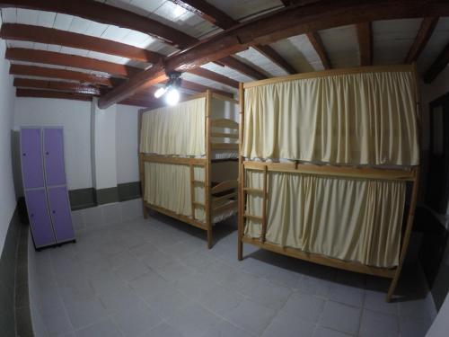 a room with two bunk beds and a purple door at Aldeia Hostel in Manaus