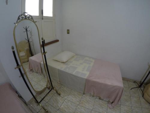 a hospital room with a bed and a mirror at Aldeia Hostel in Manaus