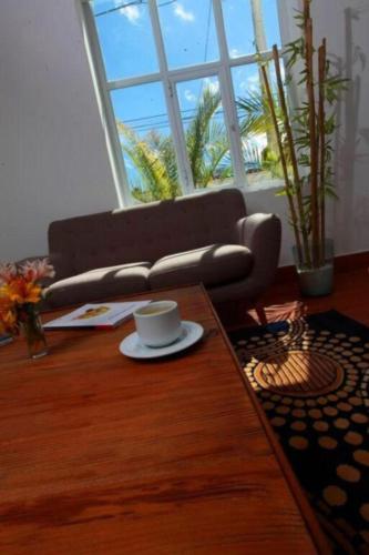 a coffee table in a living room with a coffee cup at Hotel Gran Palma Huancayo in Huancayo