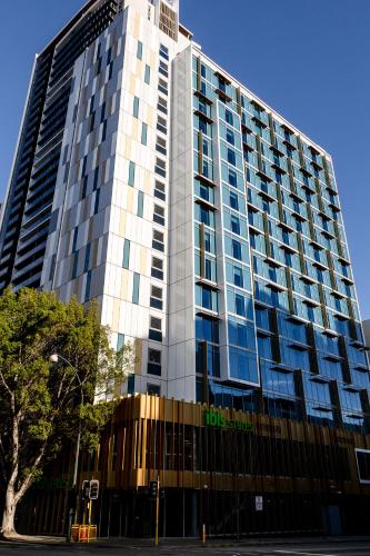 a tall building with a lot of windows at ibis Styles East Perth in Perth