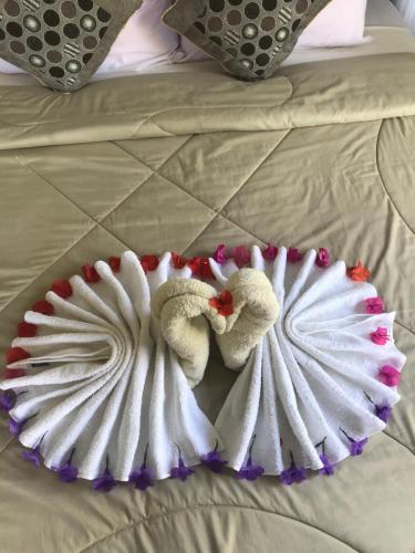 two towels laying on top of a bed at Sugi Gede Homestay in Singaraja