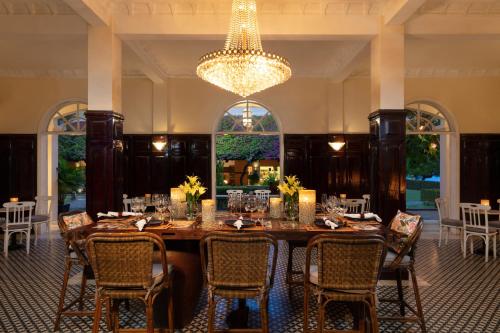 a dining room with a table and chairs and a chandelier at Anantara Hoi An Resort in Hoi An