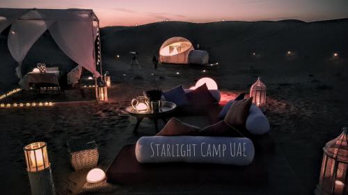 a room with a tent and a table and lights at STARLIGHT CAMP in Dubai