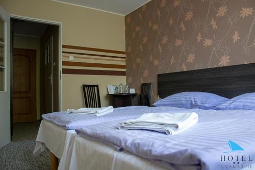 a bedroom with a bed with towels on it at Na Skarpie in Olsztyn