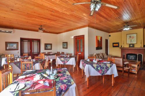 a dining room filled with tables and chairs at Berg en Zee Guesthouse in Gordonʼs Bay
