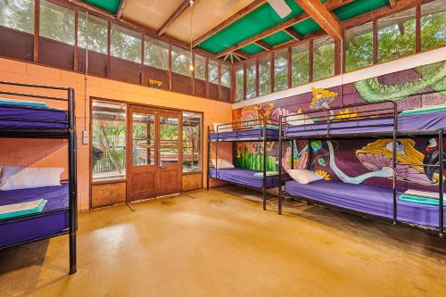 two bunk beds in a room with a mural at Arts Factory by Nomads in Byron Bay