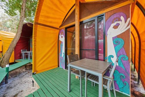 a small tent with a table in front of it at Arts Factory by Nomads in Byron Bay