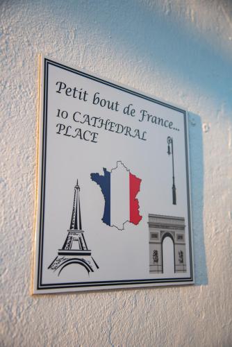 a sign hanging on a wall with the eiffel tower at PETIT BOUT DE FRANCE in Saint Augustine