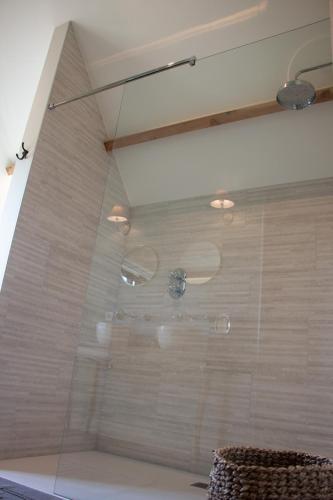 a shower with a glass door in a bathroom at Madelette B&B in Moorslede