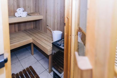 a small room with a sauna with a bench and towels at Hotel Schönwies in Trodena